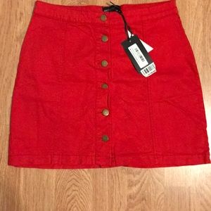 Pretty Little Thing red button skirt.